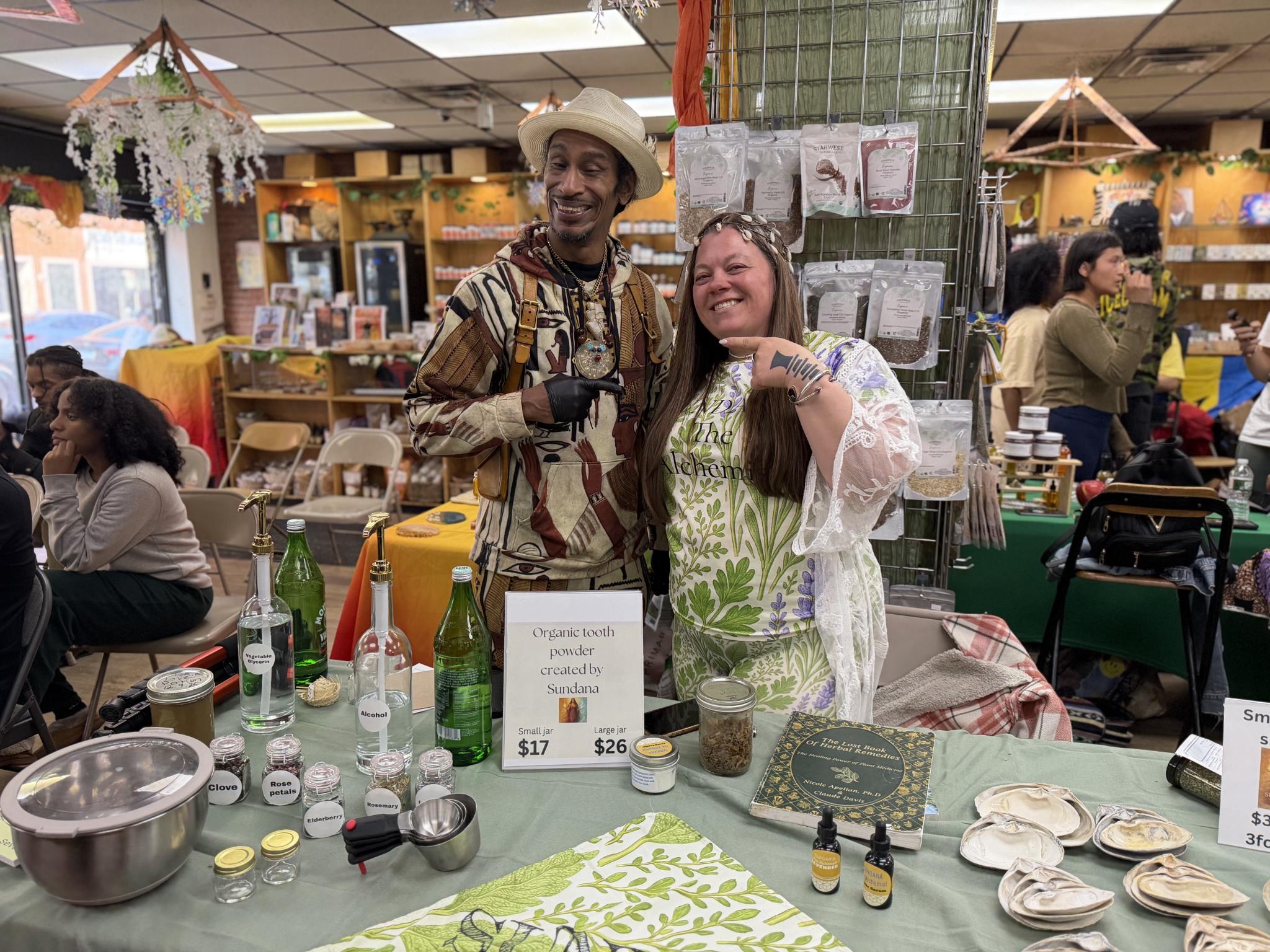 A local herbalist vendor sharing handmade products at a Nicholas Brooklyn market day